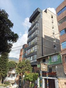 a tall building on the side of a street at perla del norte in Bello