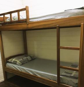 a bunk bed in a room with a bunk bed on top at Estância Colibri in Paraty
