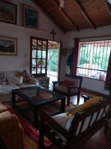 a living room with a couch and a coffee table at Casa de campo en tafi del valle in San Miguel de Tucumán