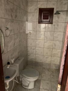 a bathroom with a toilet and a sink at Casa em Paracuru in Paracuru