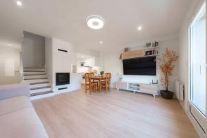 a living room with a table and a dining room at El Ventanal de Collarada in Villanúa