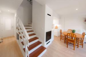 a room with a staircase and a table and a dining room at El Ventanal de Collarada in Villanúa