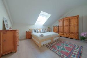 a bedroom with a bed and wooden cabinets and a rug at El Ventanal de Collarada in Villanúa