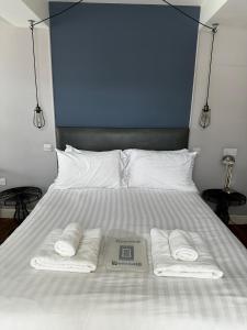 a bed with two towels and a scale on it at Castle Hotel in Aberaeron
