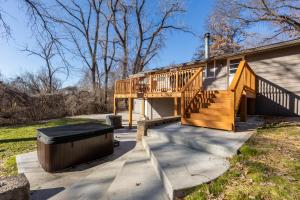 a house with a deck and a trash can next to it at Kansas City Riverside Retreat in Kansas City