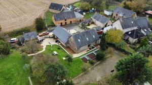 an aerial view of a large house with a barn at Le Petite Barn in Vautorte