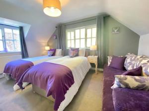 a bedroom with two beds and a couch at Quarry House in Presteigne