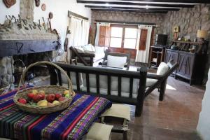 a living room with a basket of fruit on a bench at Los Abuelos Anillaco in Anillaco