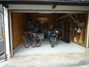 a garage with two bikes parked in it at GuestHouse AZMO - Vacation STAY 35375v in Matsue