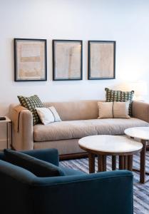 a living room with a couch and two tables at Escape to Revy - Beautifully Designed Condo in Revelstoke