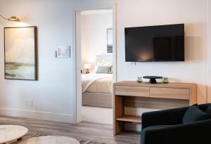 a living room with a television and a bed at Escape to Revy - Beautifully Designed Condo in Revelstoke +21 photos