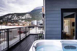 a balcony with a view of a body of water at Escape to Revy - Beautifully Designed Condo in Revelstoke