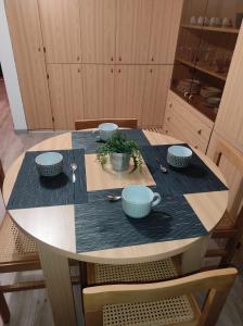 a table with bowls and cups on top of it at Presolana House in Castione della Presolana