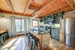 a kitchen with wooden ceilings and a wooden floor at Bryson City Cabin Deck and Mountain-View Hot Tub in Nantahala
