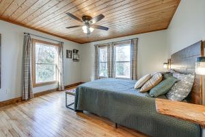 a bedroom with a bed and a ceiling fan at Bryson City Cabin Deck and Mountain-View Hot Tub in Nantahala