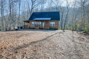 a small cabin in the middle of a dirt road at Bryson City Cabin Deck and Mountain-View Hot Tub in Nantahala
