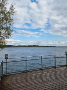 a wooden deck with a view of a body of water at Aquarius Resort in Lappajärvi