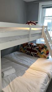 a bedroom with two bunk beds in a room at Stay In Oxford Street in London