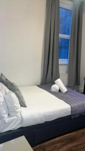 a bed in a room with a window at Stay In Oxford Street in London