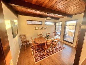 a dining room with a table and chairs at Whitehorse Home on the River in Whitehorse