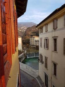 a view of a river from between two buildings at La Casa dei Turchi in Rovereto