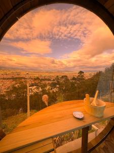 a wooden table with a bowl on top of it at NaturHotel in Cuenca