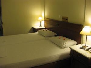 A bed or beds in a room at Florena Hotel
