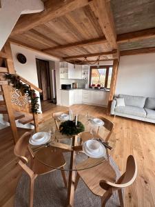 ein Wohnzimmer mit einem Glastisch und Stühlen in der Unterkunft Domek IGNAC in Ostrowsko