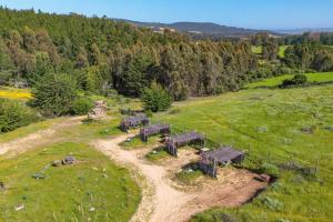 an aerial view of a farm with animals in a field at Olas de Chile Ecocamp in Pichilemu