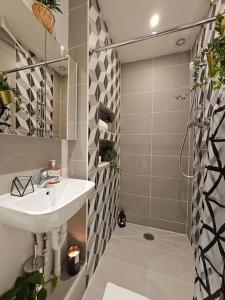a bathroom with a sink and a shower at Beautiful and spacious flat in London