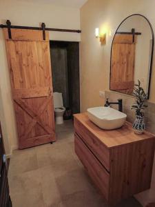 a bathroom with a sink and a mirror and a door at Grand T3 dans le centre historique in Agen