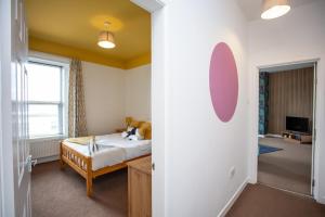 a bedroom with a bed and a room with a tv at The Elswick in Elswick