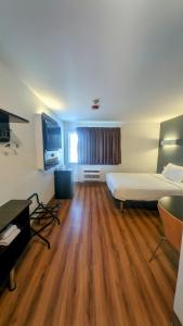 a large room with a bed and a television at Econo Lodge in Idaho Falls