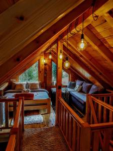 a bedroom in a log cabin with a bed at Planinska kuća MESECEV PUT in Bajina Bašta