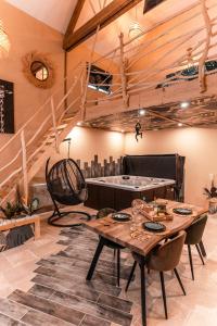 a dining room with a table and a staircase at Spa nature in Vimy