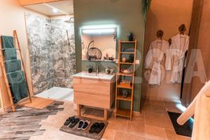 a bathroom with a sink and a shower at Spa nature in Vimy
