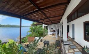 an outdoor patio with a view of the water at Hotel Sunset Rooms in Tortuguero