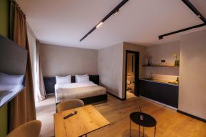 a hotel room with a bed and a table at 1863 Boutique Hotel in Peje