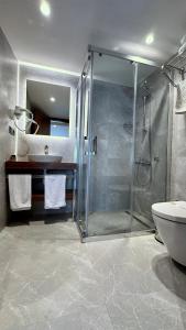 a bathroom with a shower and a toilet and a sink at Snog Rooms & Suites in Istanbul +16 photos