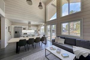 a living room with a couch and a table at Holy Moly by Hilla Villas in Pelkosenniemi