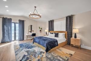 a bedroom with a bed and a desk in a room at Lauderdale By The Sea home in Fort Lauderdale
