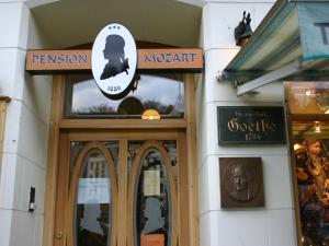 a front door of a museum with a sign above it at EA Hotel Mozart in Karlovy Vary