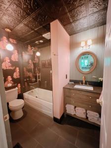 a bathroom with a tub and a toilet and a sink at The River Farmhouse in Corbyville +16 photos