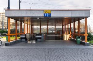 a bus stop with a bus stop at Stay2gether City Buzz Apt - O2 arena - Sleeps 6 in Prague