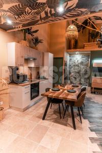 a kitchen with a wooden table and some chairs at Spa nature in Vimy