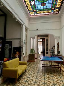 a living room with a pool table and a stained glass ceiling at Hostel Bohemian House in Montevideo