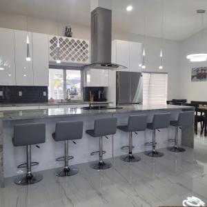 a kitchen with a large counter with bar stools at Sunsets by the Water in Cape Coral