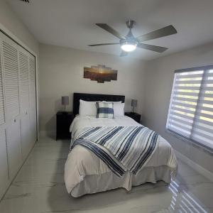 a bedroom with a bed with a ceiling fan at Sunsets by the Water in Cape Coral