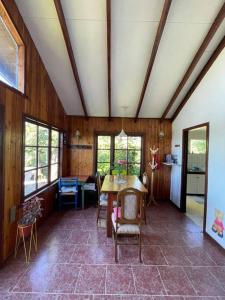 a room with a table and chairs in a house at Cabaña con vista al Lago in Ranco