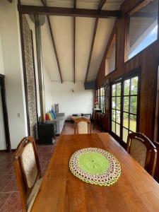 a dining room with a wooden table with a plate on it at Cabaña con vista al Lago in Ranco